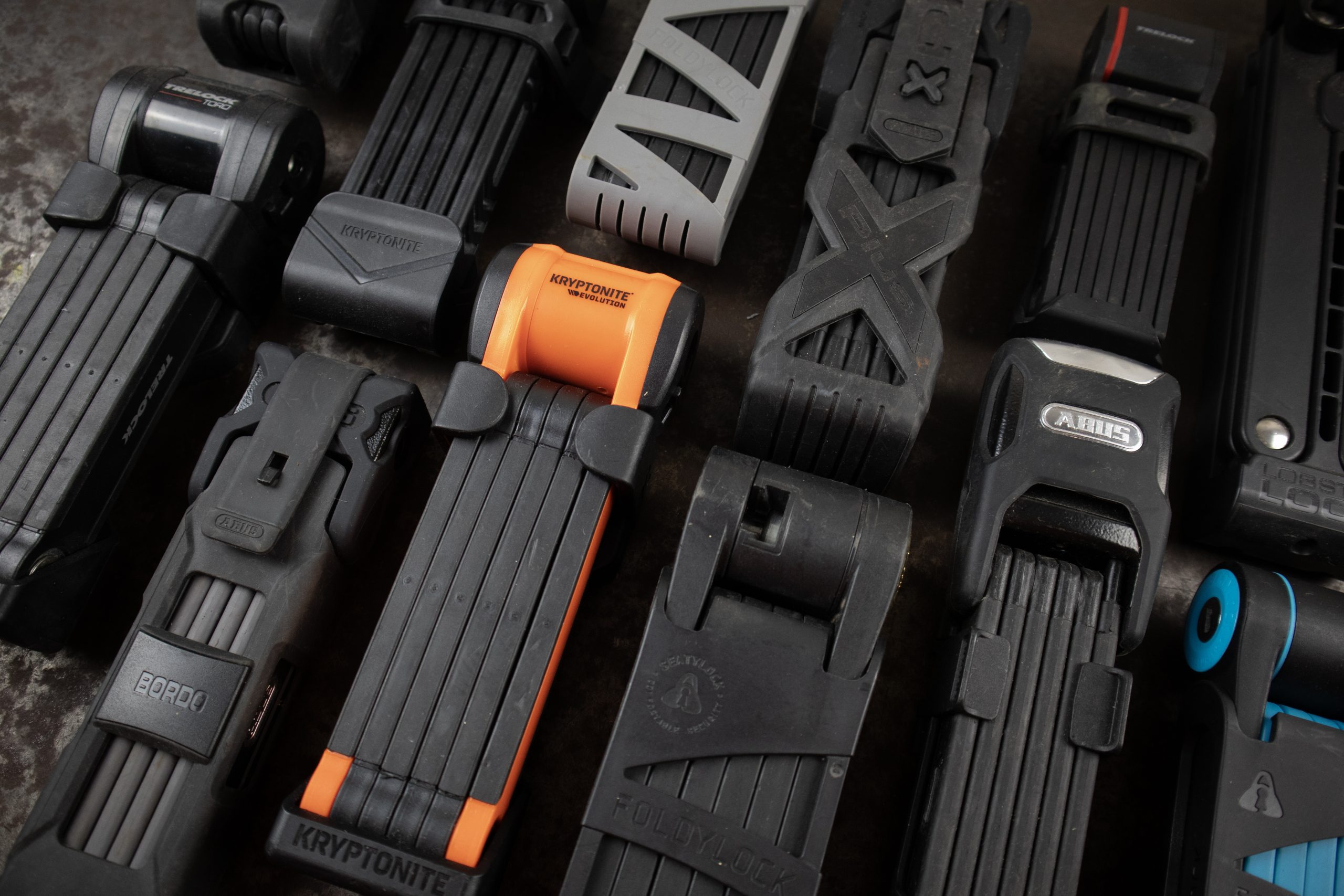 Many types of folding bike locks together on a metal table